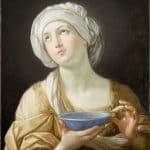 woman wearing white headdress while holding blue bowl painting